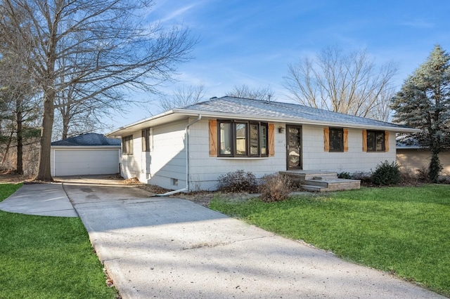 single story home with a front yard, a garage, and an outdoor structure