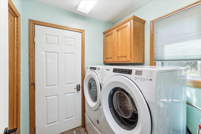 laundry room featuring cabinets and washing machine and clothes dryer