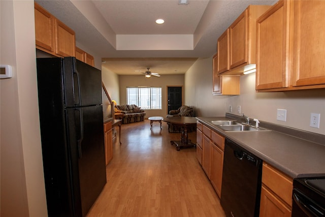 kitchen featuring ceiling fan, sink, light hardwood / wood-style flooring, and black appliances