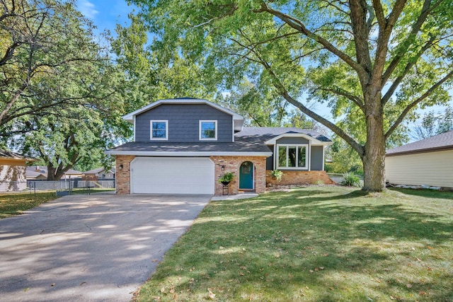 split level home with a front lawn and a garage