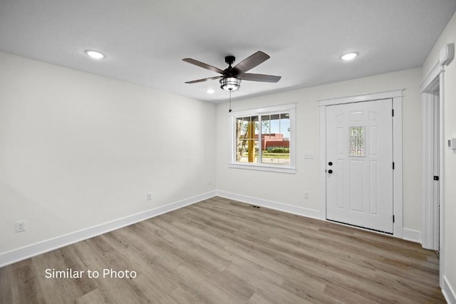 foyer with ceiling fan and light hardwood / wood-style floors