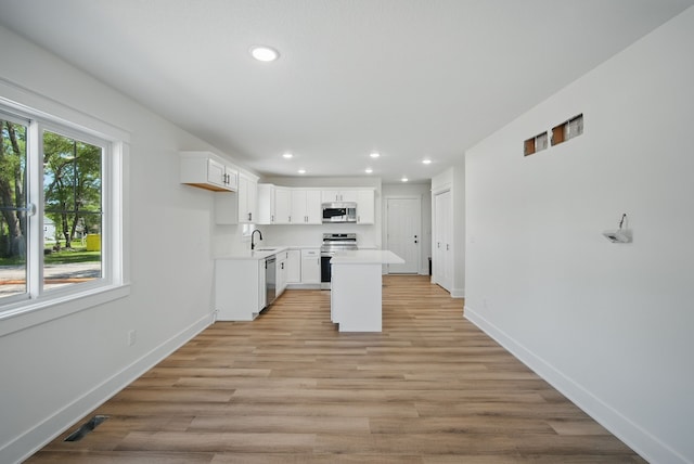 2527 Shaw St, Des Moines, IA 50317 - kitchen with appliances with stainless steel finishes, a sink, recessed lighting, light countertops, and baseboards