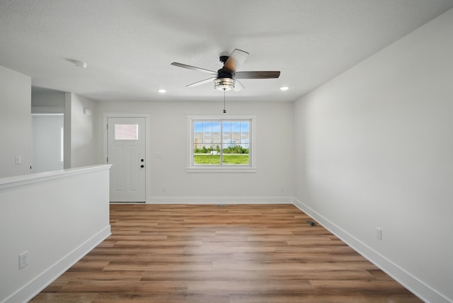 2527 Shaw St, Des Moines, IA 50317 - empty room featuring ceiling fan, wood finished floors, baseboards, and recessed lighting