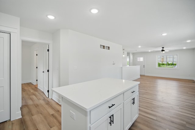 2527 Shaw St, Des Moines, IA 50317 - kitchen featuring a kitchen island, light countertops, a ceiling fan, recessed lighting, and white cabinets