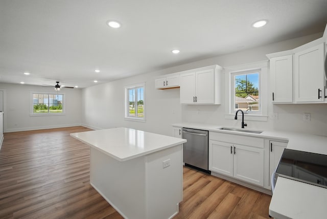 2527 Shaw St, Des Moines, IA 50317 - kitchen with stainless steel dishwasher, a sink, recessed lighting, light wood-style floors, and a center island