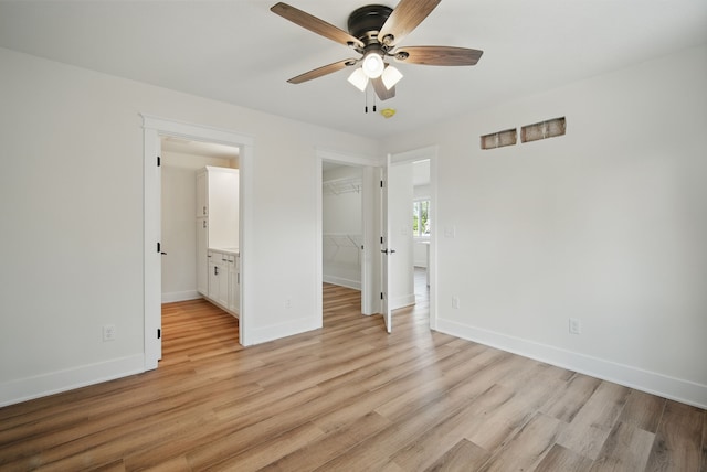 2527 Shaw St, Des Moines, IA 50317 - unfurnished bedroom featuring a spacious closet, light wood finished floors, baseboards, and a closet