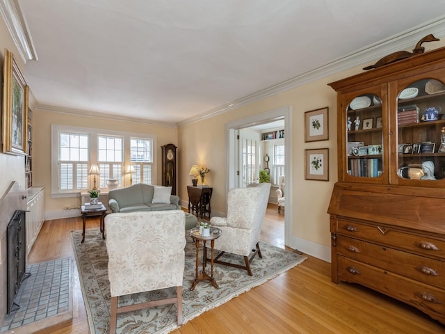 living room with crown molding and light hardwood / wood-style flooring