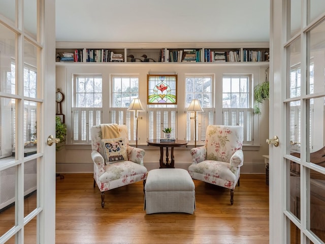 sunroom with a healthy amount of sunlight, french doors, and radiator heating unit