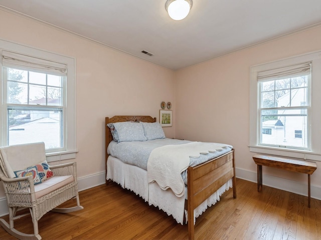 bedroom with hardwood / wood-style flooring