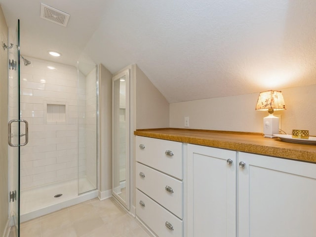 bathroom featuring a shower with door