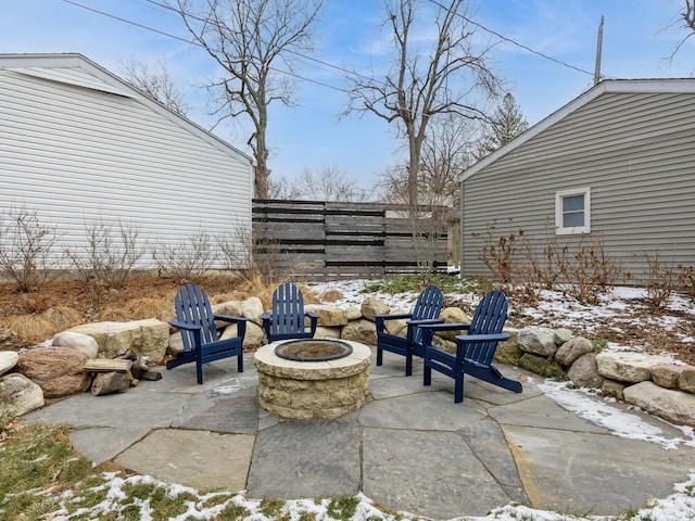 snow covered patio featuring a fire pit