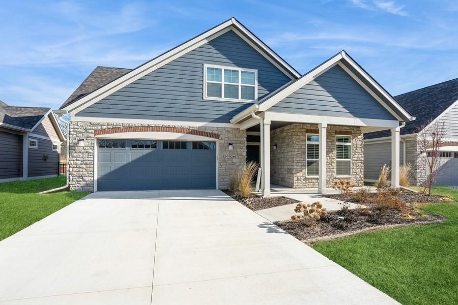 craftsman inspired home featuring a front yard and a garage