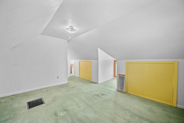 bonus room with carpet and vaulted ceiling