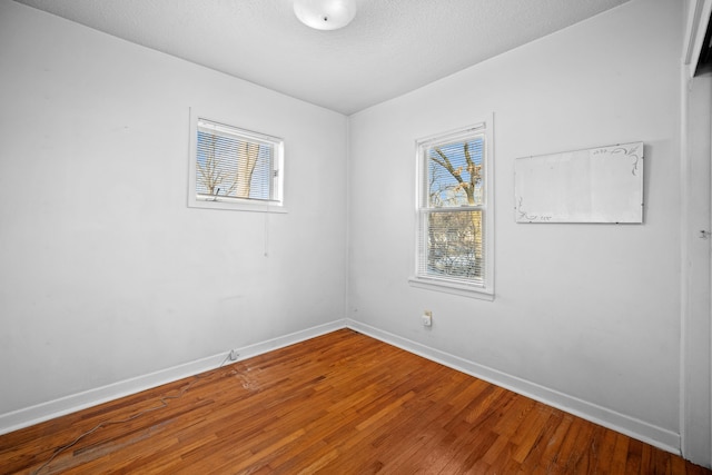 spare room with hardwood / wood-style flooring