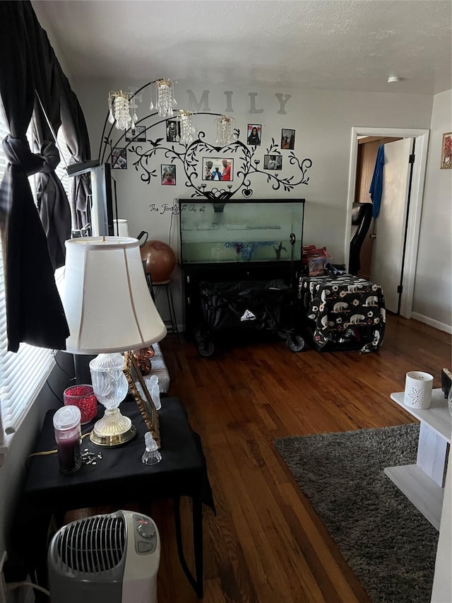 living room with a textured ceiling and hardwood / wood-style floors