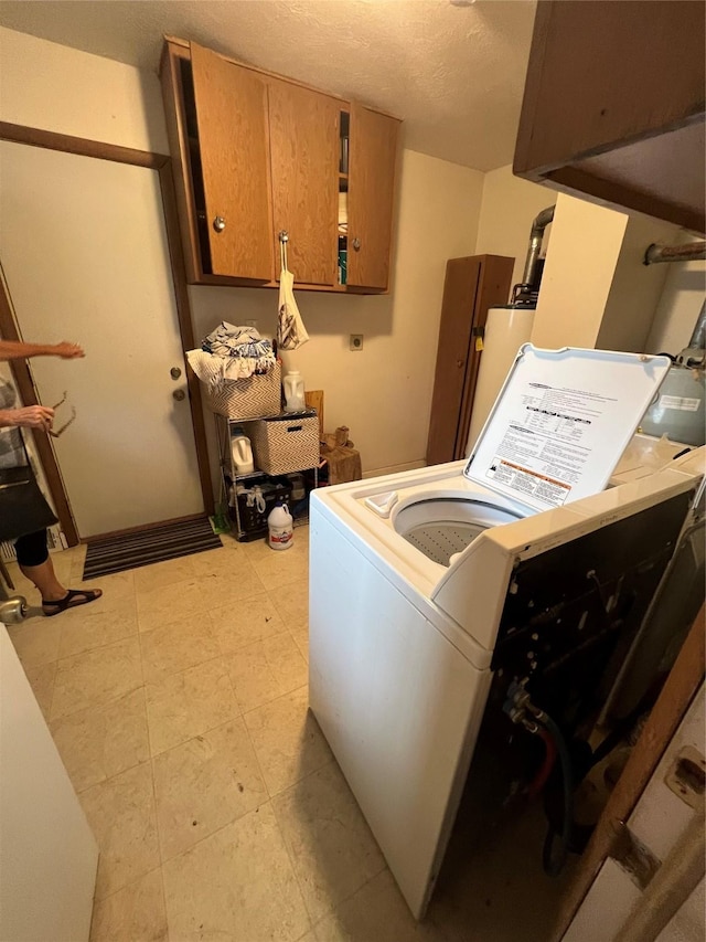 washroom with cabinets and washer / clothes dryer