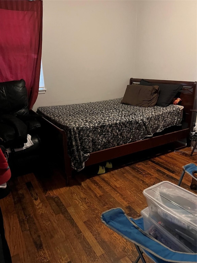 bedroom with dark wood-type flooring