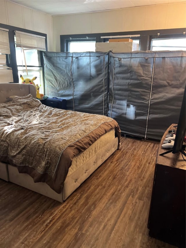 bedroom featuring hardwood / wood-style floors and multiple windows