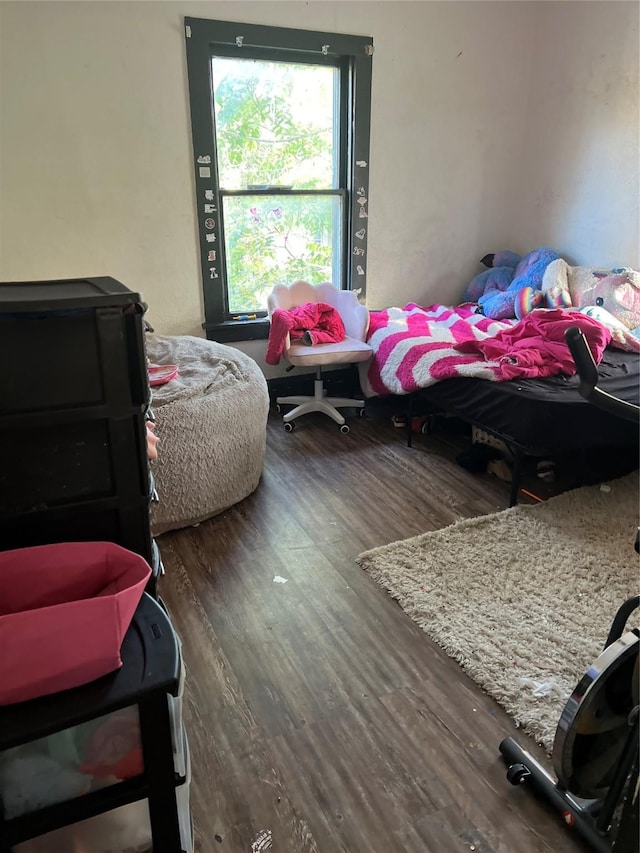 bedroom with dark wood-type flooring