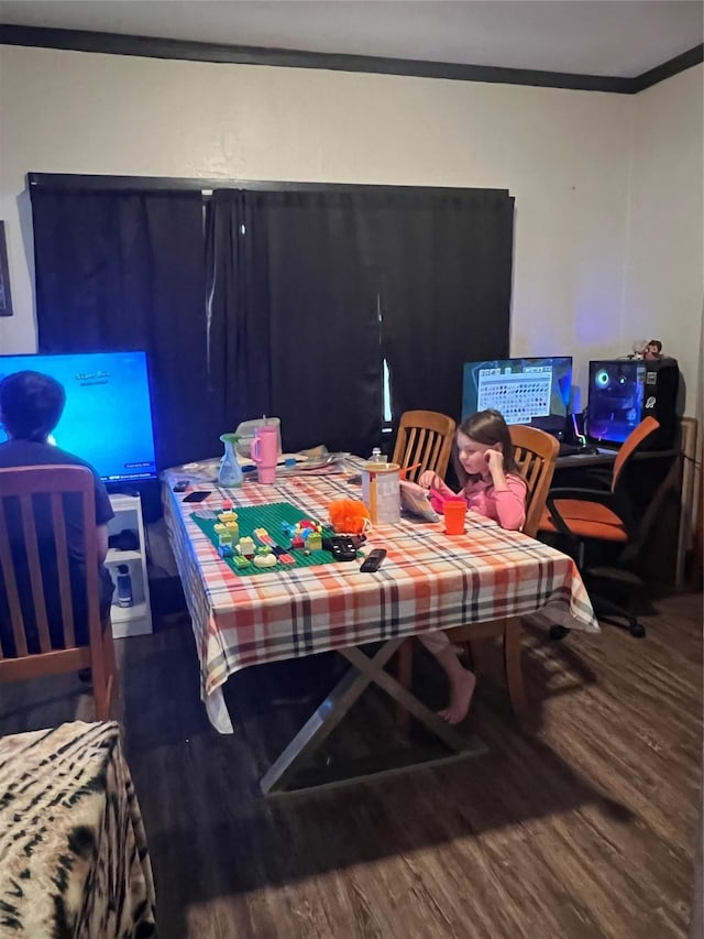 dining room with wood-type flooring and crown molding