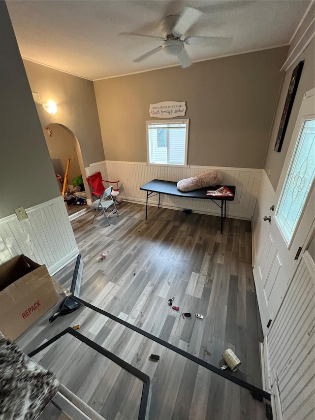 playroom with a textured ceiling, ceiling fan, and wood-type flooring