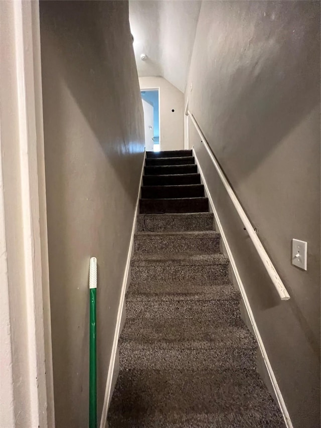 stairway with vaulted ceiling