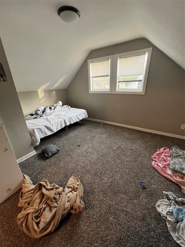 unfurnished bedroom with carpet and lofted ceiling