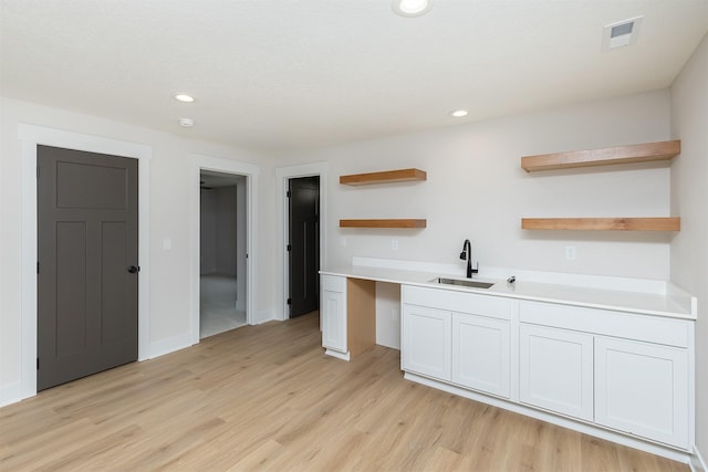 2390 Emma Ave, Des Moines, IA 50321 - kitchen with open shelves, light wood-style floors, light countertops, and recessed lighting
