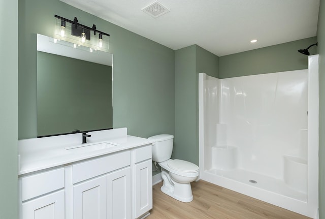 2390 Emma Ave, Des Moines, IA 50321 - bathroom featuring wood finished floors, vanity, and a shower