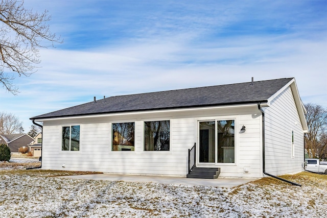 2390 Emma Ave, Des Moines, IA 50321 - snow covered property with entry steps and a shingled roof