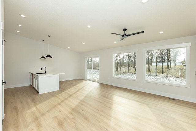 2390 Emma Ave, Des Moines, IA 50321 - unfurnished living room featuring ceiling fan, light wood finished floors, recessed lighting, and lofted ceiling