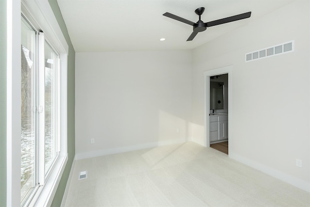 2390 Emma Ave, Des Moines, IA 50321 - carpeted empty room with plenty of natural light and ceiling fan