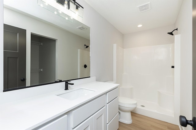 2390 Emma Ave, Des Moines, IA 50321 - bathroom featuring vanity, wood finished floors, and a shower