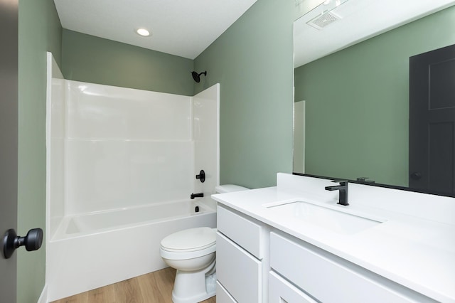 2390 Emma Ave, Des Moines, IA 50321 - bathroom with wood finished floors, vanity, shower / bath combination, and recessed lighting