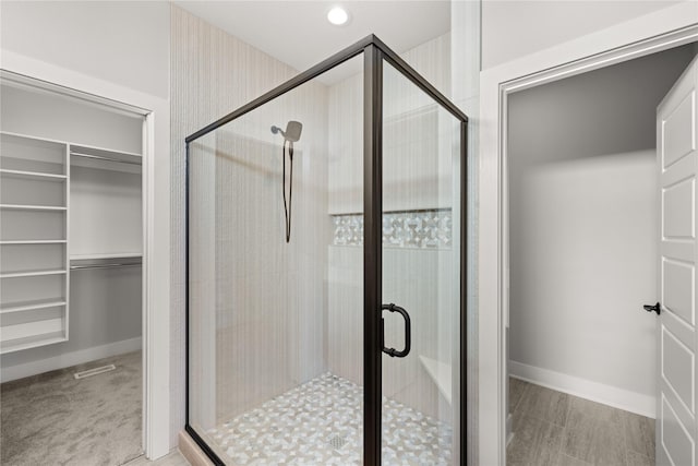 bathroom featuring a shower with shower door