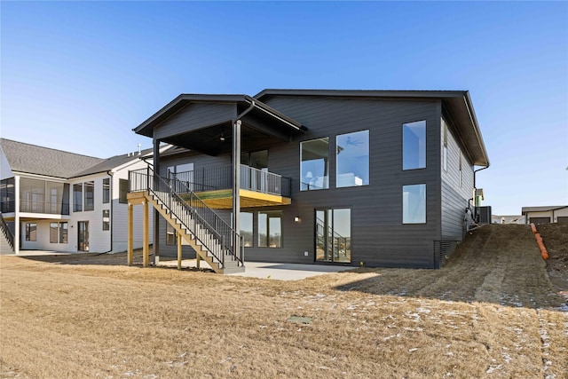 back of property featuring central air condition unit and a patio