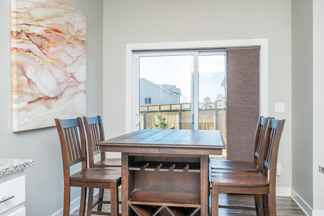 dining space with dark hardwood / wood-style flooring