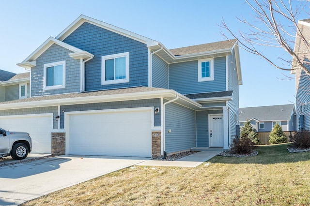 view of front of house featuring a front yard and a garage