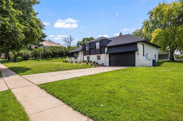 view of front of house with a garage and a front lawn