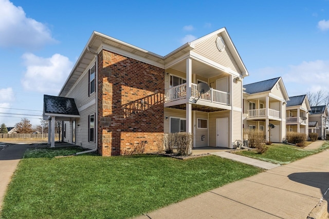 view of front of property with a balcony and a front lawn