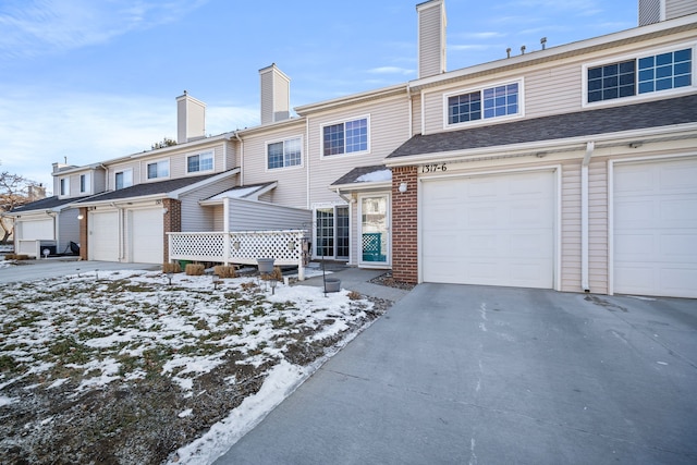 townhome / multi-family property featuring a garage