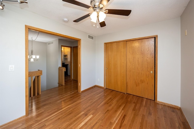 unfurnished bedroom with visible vents, baseboards, a closet, and light wood-style flooring