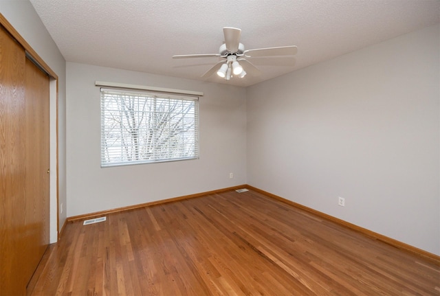 unfurnished bedroom featuring a closet, visible vents, light wood-style flooring, and baseboards