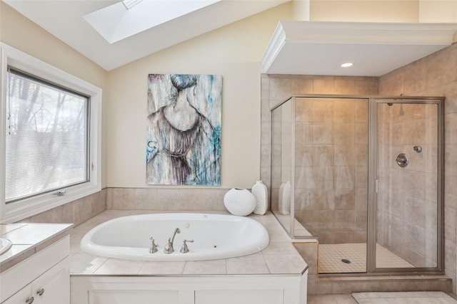 bathroom featuring vaulted ceiling with skylight, vanity, and plus walk in shower