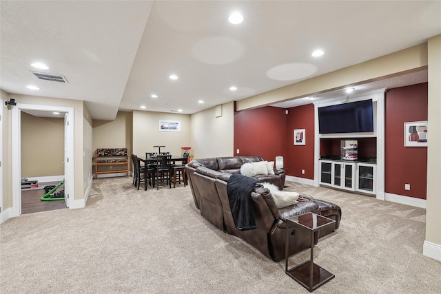 carpeted living area featuring baseboards, recessed lighting, and visible vents