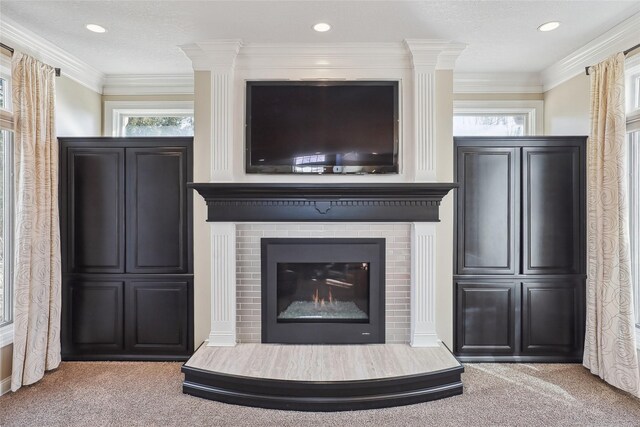 details featuring a brick fireplace, ornamental molding, and carpet flooring