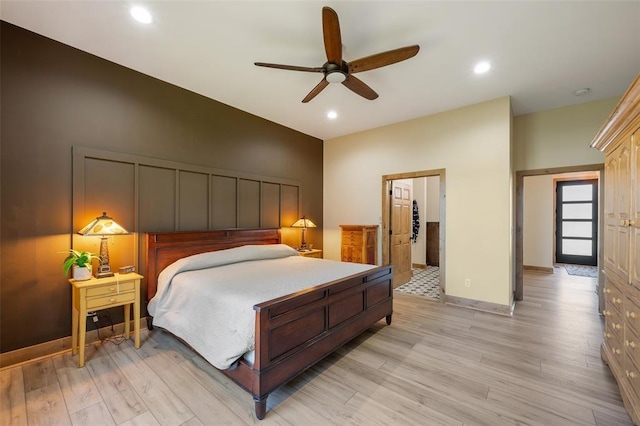 bedroom with ceiling fan and light hardwood / wood-style floors