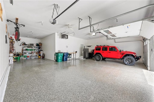 garage with a garage door opener and ceiling fan