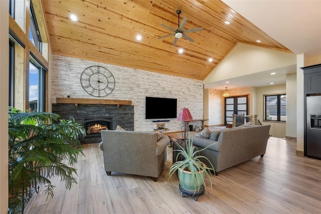 living room featuring wooden ceiling, ceiling fan, a fireplace, high vaulted ceiling, and light hardwood / wood-style flooring