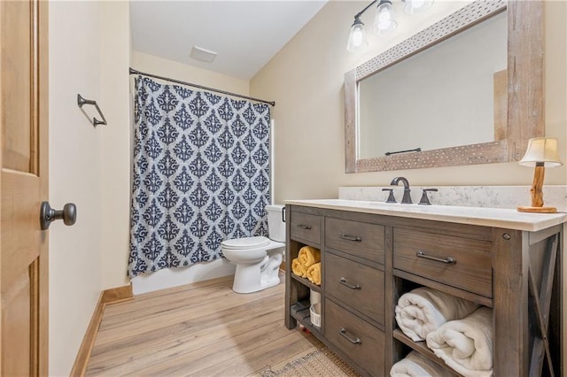 bathroom with wood-type flooring, toilet, and vanity